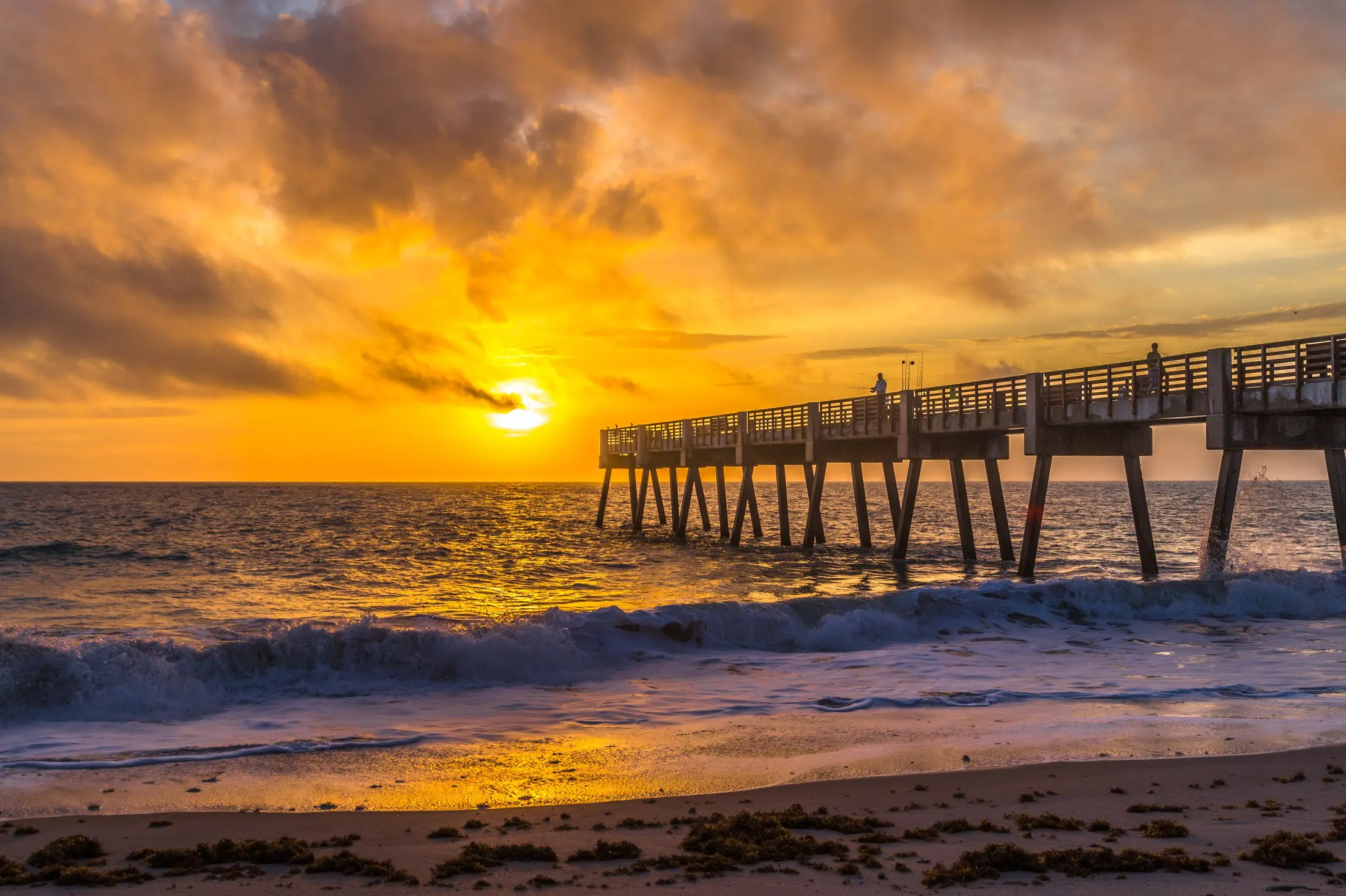 Golden-hour beach pier after a strong photo window appears.